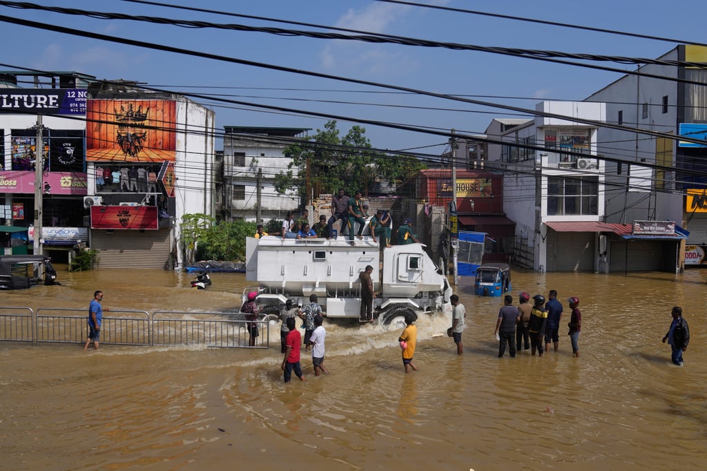 A military vehicle carries flood victims through a submerged area to safety in Colombo, Sri Lanka, on Sunday. Photo: AP
