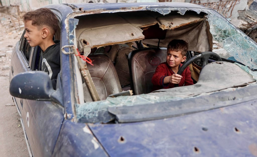 Displaced Palestinian children play in the wreckage of a car in the Tel al-Hawa neighbourhood of Gaza City on Saturday. Photo: AFP Displaced Palestinian children play in the wreckage of a car in the Tel al-Hawa neighbourhood of Gaza City on Saturday. Photo: AFP