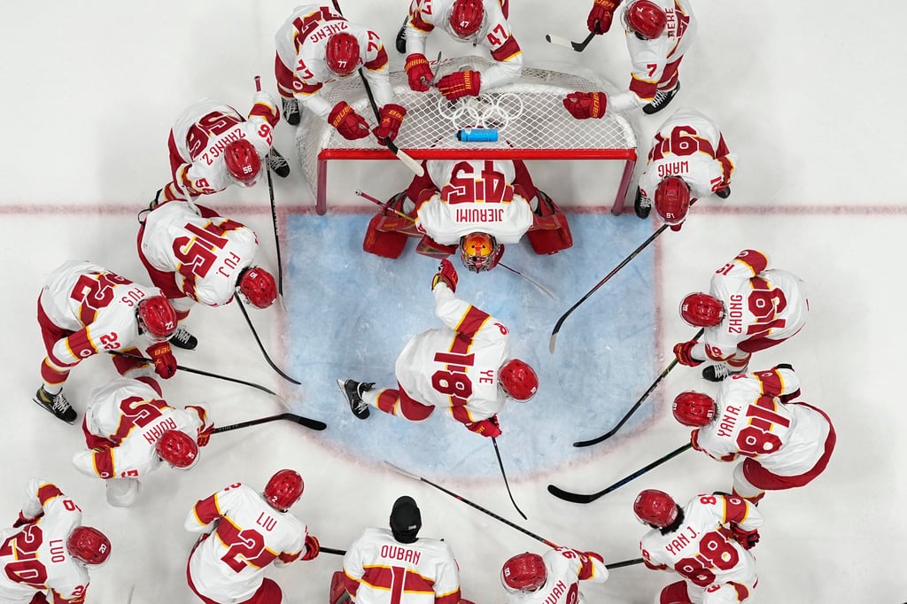 China’s players gather around before a game at the 2022 Winter Olympics in Beijing. Photo: AP