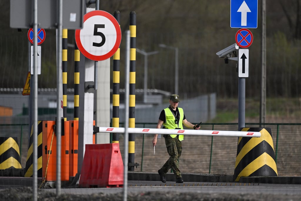 A Polish border guard opens a gate at a Polish-Ukrainian border crossing in March last year. Photo: AFP