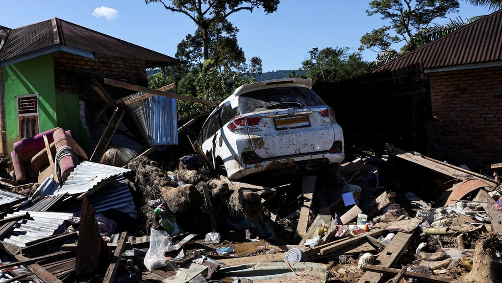A car sits on top of flood debris in Palembayan, West Sumatra, on Monday. Photo: Reuters
