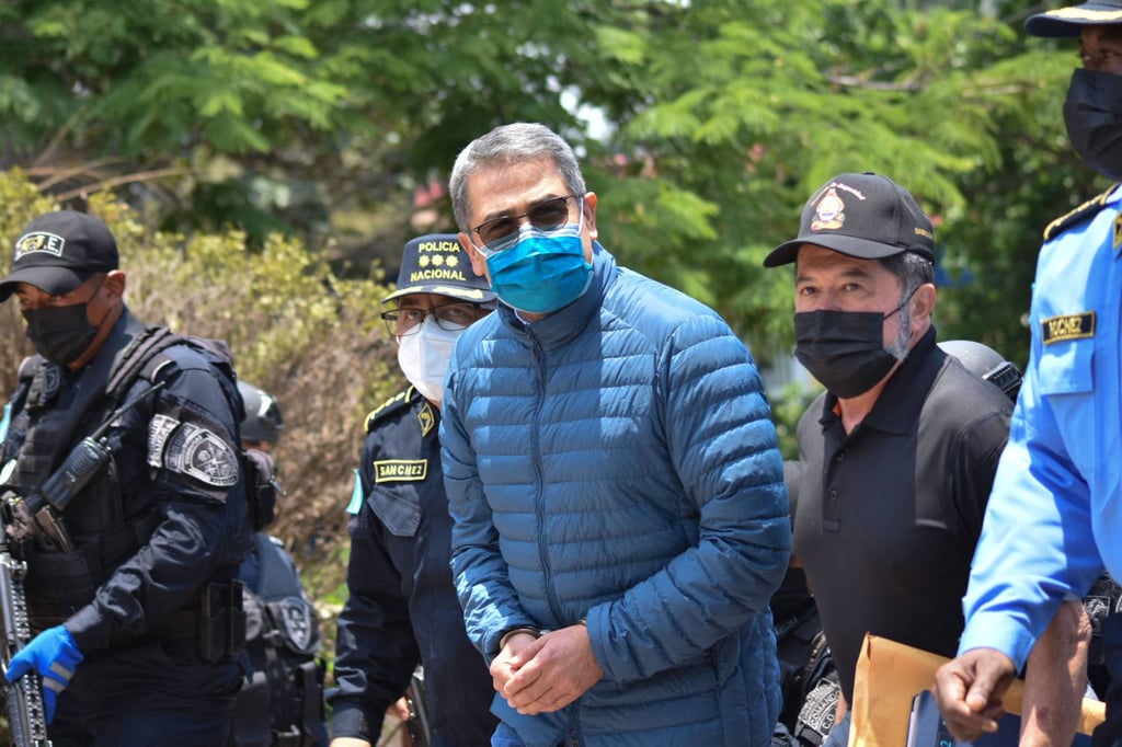 Juan Orlando Hernandez is escorted by police before his extradition to the US to face drug-trafficking related charges, in Tegucigalpa, Honduras in April 2022. Photo: AFP