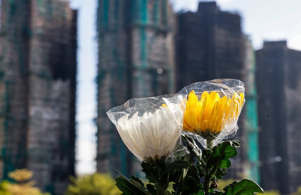 Flowers are seen next to the buildings at Wang Fuk Court in Tai Po on Tuesday after last week’s deadly fire. Photo: Reuters Flowers are seen next to the buildings at Wang Fuk Court in Tai Po on Tuesday after last week’s deadly fire. Photo: Reuters