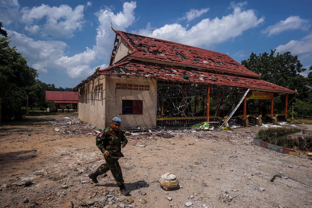 A Cambodian soldier walks past a building hit by artillery during a visit of foreign diplomats to inspect a damaged area along the Thailand-Cambodia border in August. Photo: Reuters