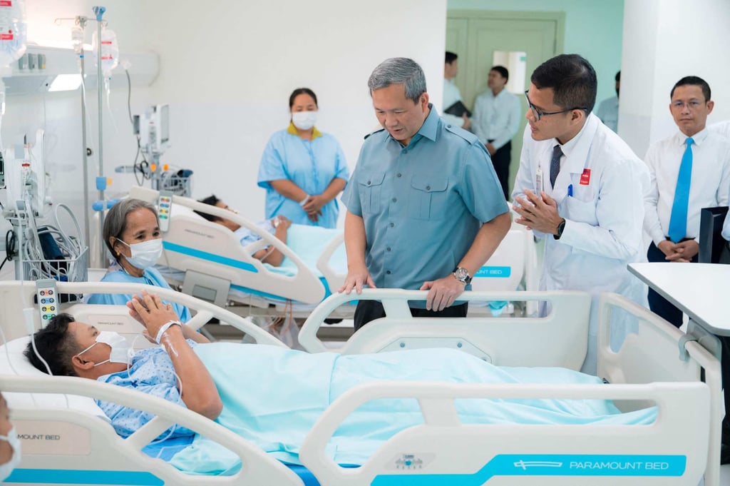 Cambodia’s Prime Minister Hun Manet meets a patient at a hospital in Phnom Penh who was injured along the Cambodia-Thailand border last month. Photo: Agence Kampuchea Press/AFP