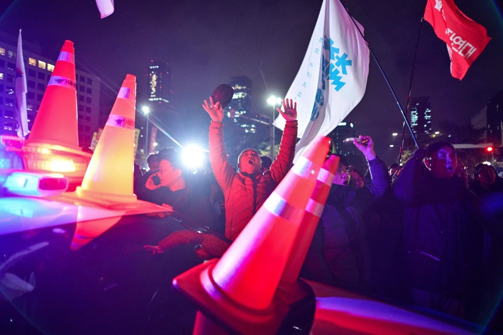 People gather outside the National Assembly in Seoul in the early morning of December 4, 2024, after then president Yoon Suk-yeol had declared martial law. Photo: AFP