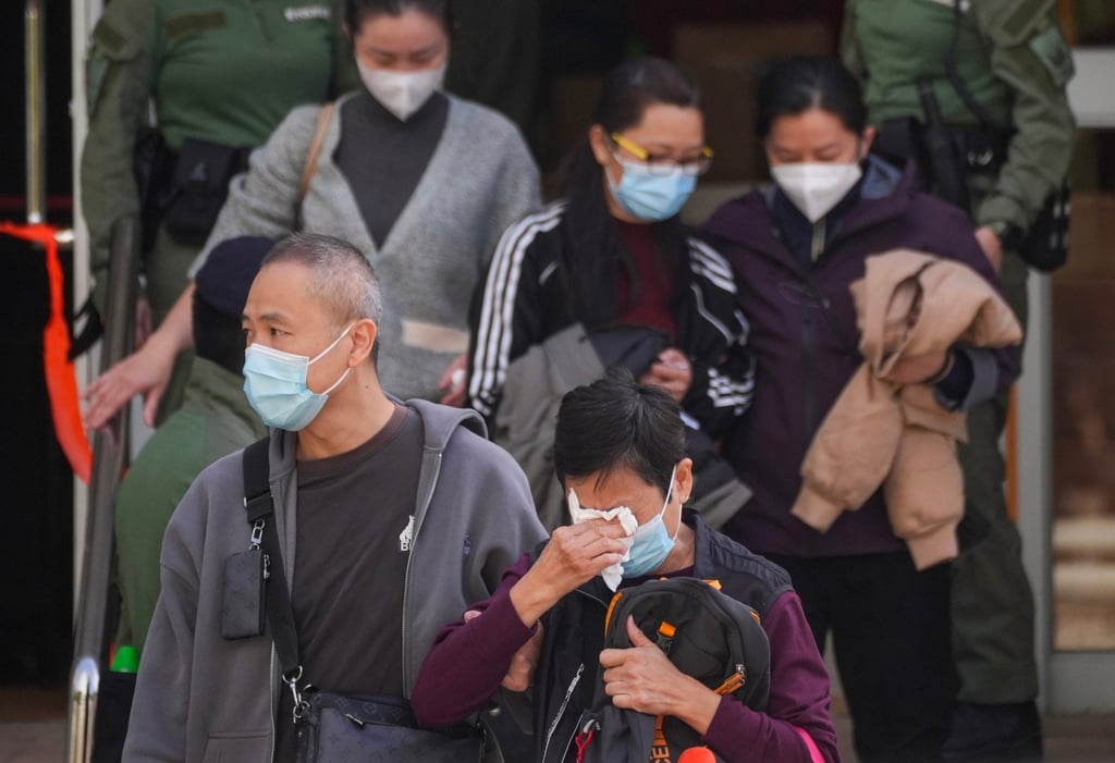 People leave Tai Po’s Kwong Fuk Community Hall after identifying deceased relatives on November 28. Photo: Elson Li