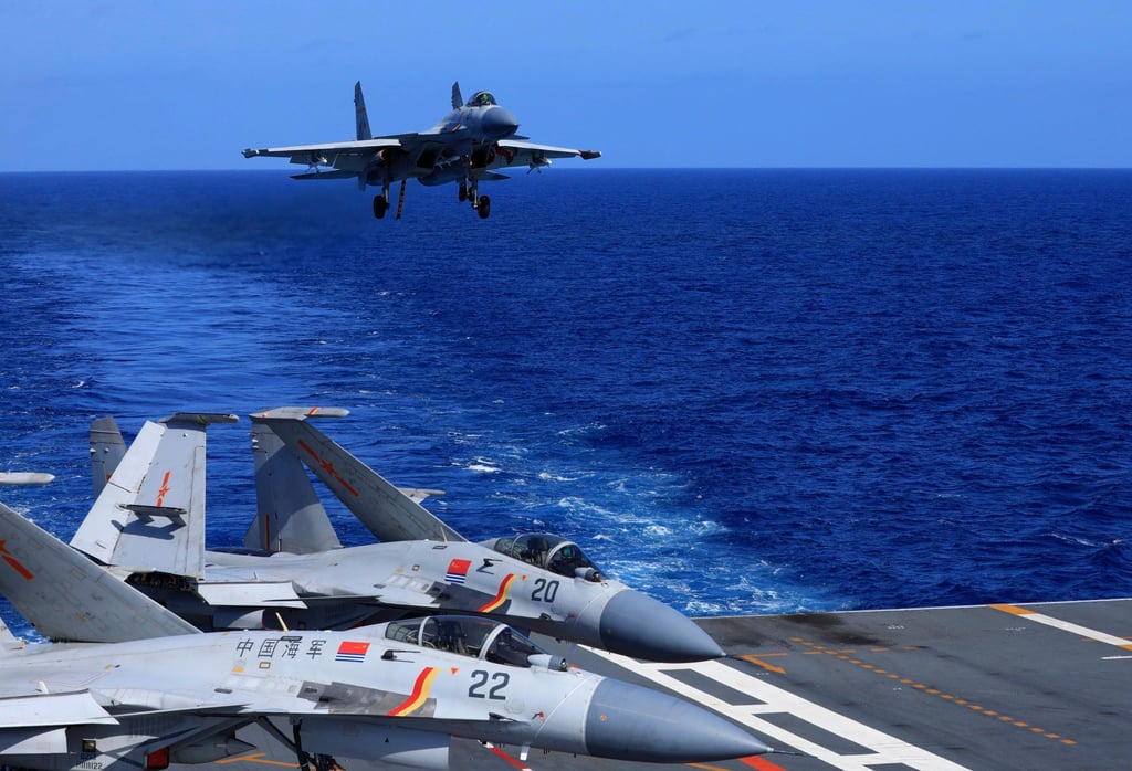 A Chinese J-15 fighter jet prepares to land on the Liaoning aircraft carrier in this photo released in December 2021. Tokyo says fighters like these locked on Japanese jets in a rare military encounter on Saturday. Photo: AP A Chinese J-15 fighter jet prepares to land on the Liaoning aircraft carrier in this photo released in December 2021. Tokyo says fighters like these locked on Japanese jets in a rare military encounter on Saturday. Photo: AP