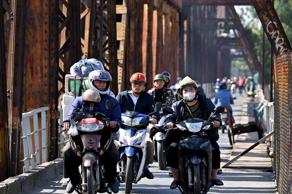 Motorists ride over the Long Bien Bridge in Hanoi. Photo: AFP