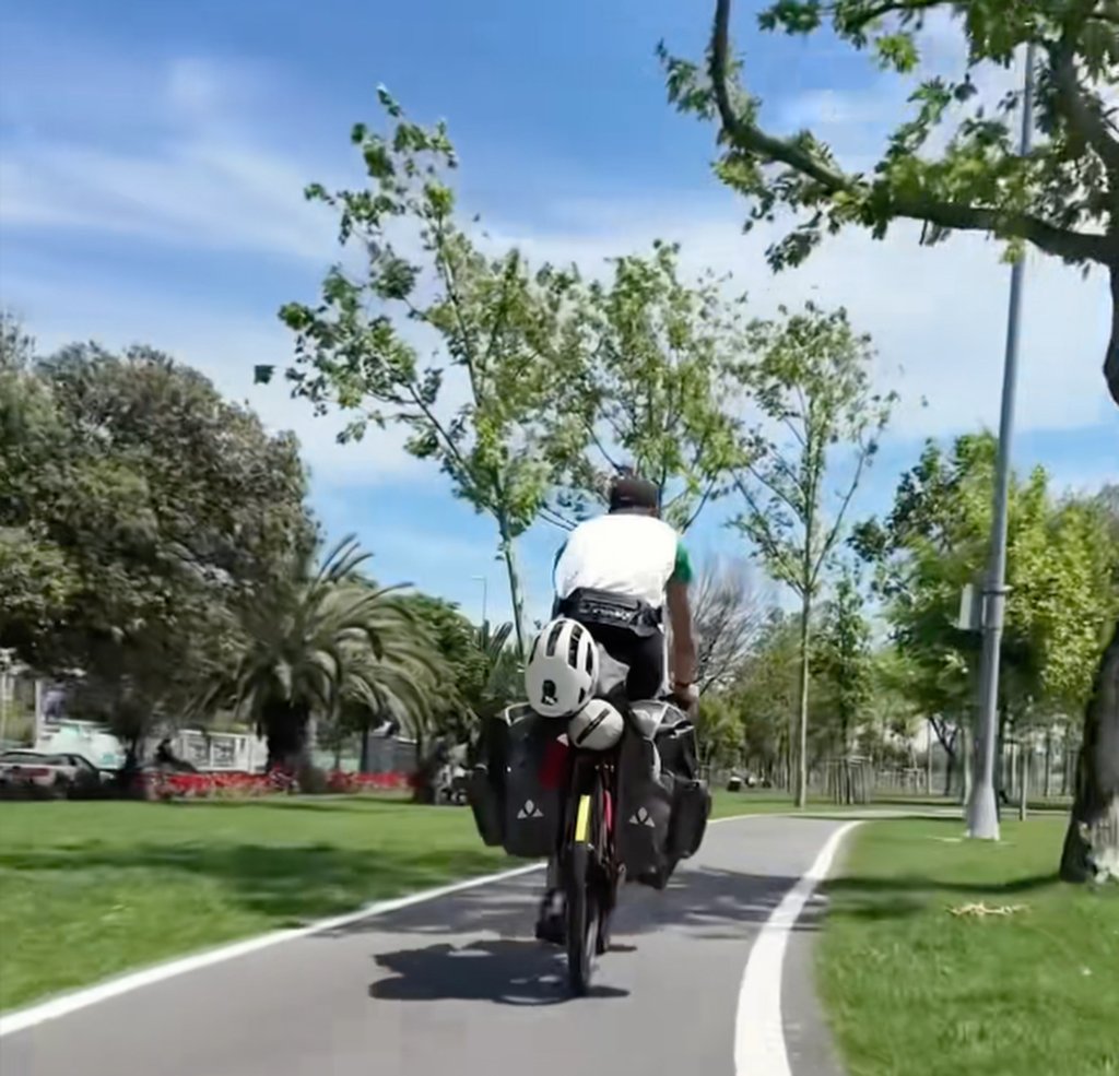 Killian Le Guyader rides his fully loaded bicycle. He travelled across more than 30 countries to get to China. Photo: Douyin
