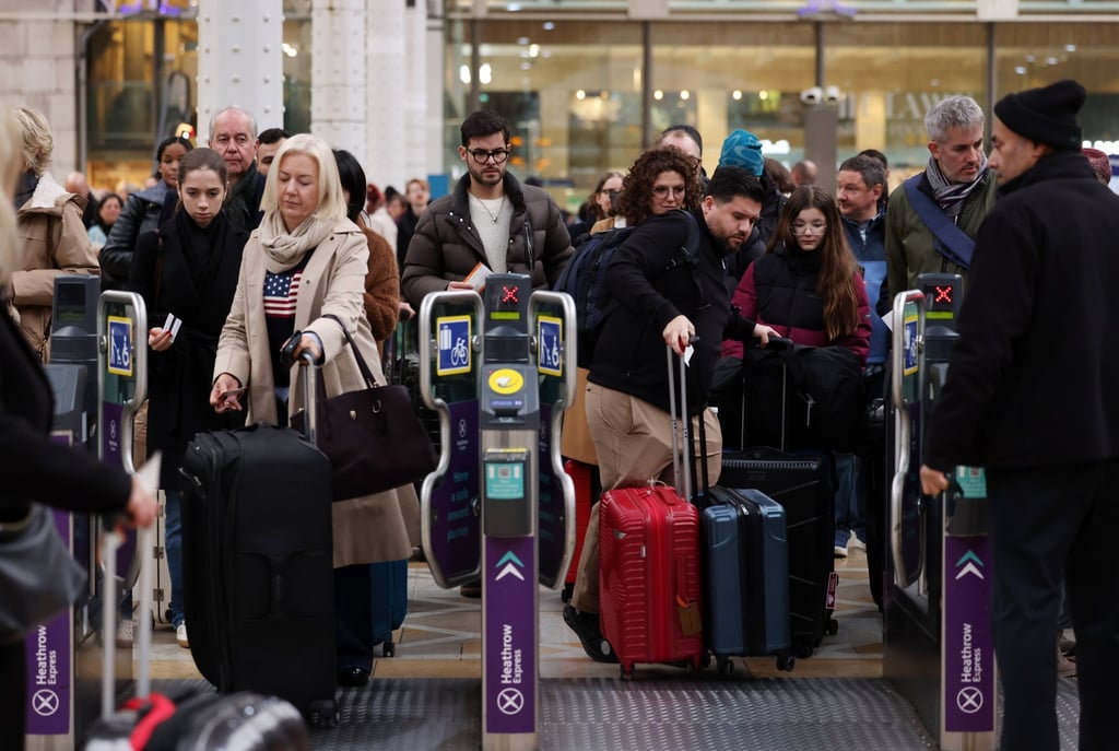 Heathrow-bound travellers board the Heathrow Express after long delays in London on Sunday following a pepper spray attack in a Heathrow car park. Photo: EPA Heathrow-bound travellers board the Heathrow Express after long delays in London on Sunday following a pepper spray attack in a Heathrow car park. Photo: EPA