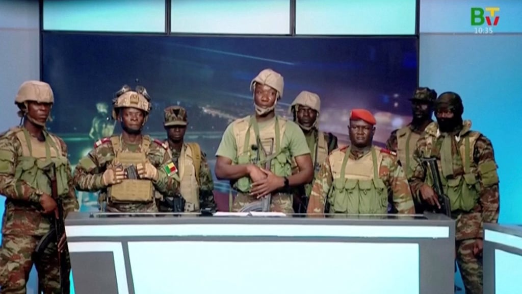 A group of soldiers give a statement on Benin’s national television, claiming to have seized power on Sunday. Photo: Benin TV via Reuters