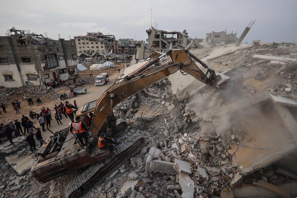 An excavator digs in the rubble of a destroyed building in the central Gaza Strip. Photo: AFP An excavator digs in the rubble of a destroyed building in the central Gaza Strip. Photo: AFP