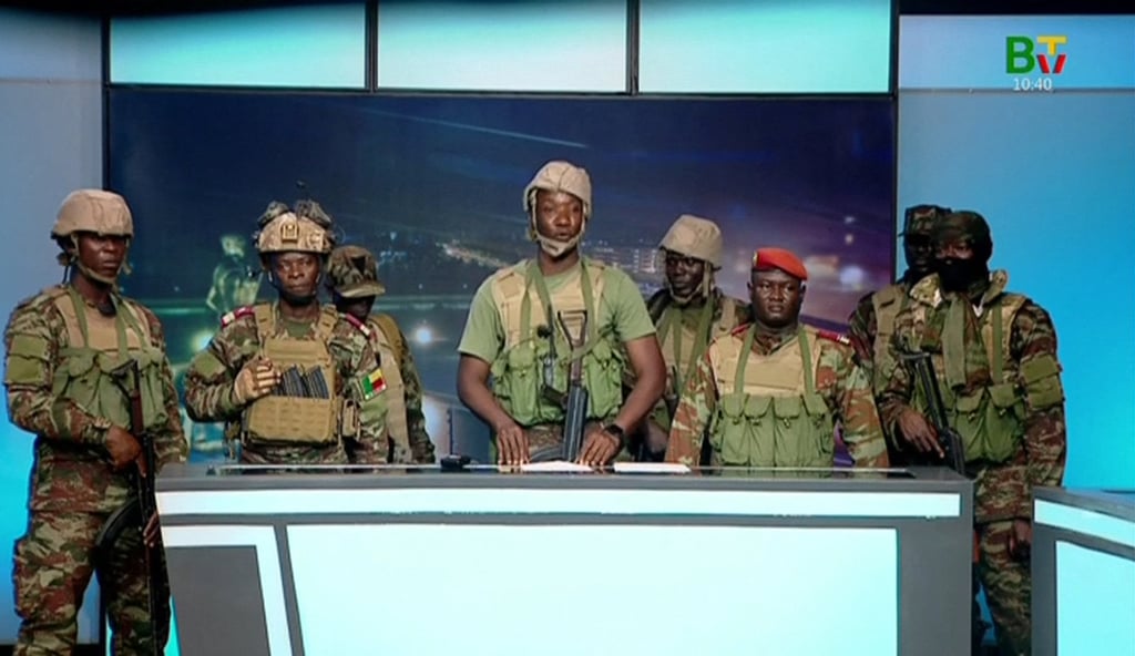 Soldiers who stormed the national television station on Sunday morning to announce the coup. Photo: Benin TV via AFP Soldiers who stormed the national television station on Sunday morning to announce the coup. Photo: Benin TV via AFP
