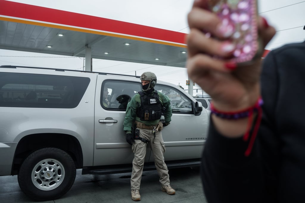 An activist films US Border Patrol agents after an attempted raid in Kenner, Louisiana. Photo: EPA