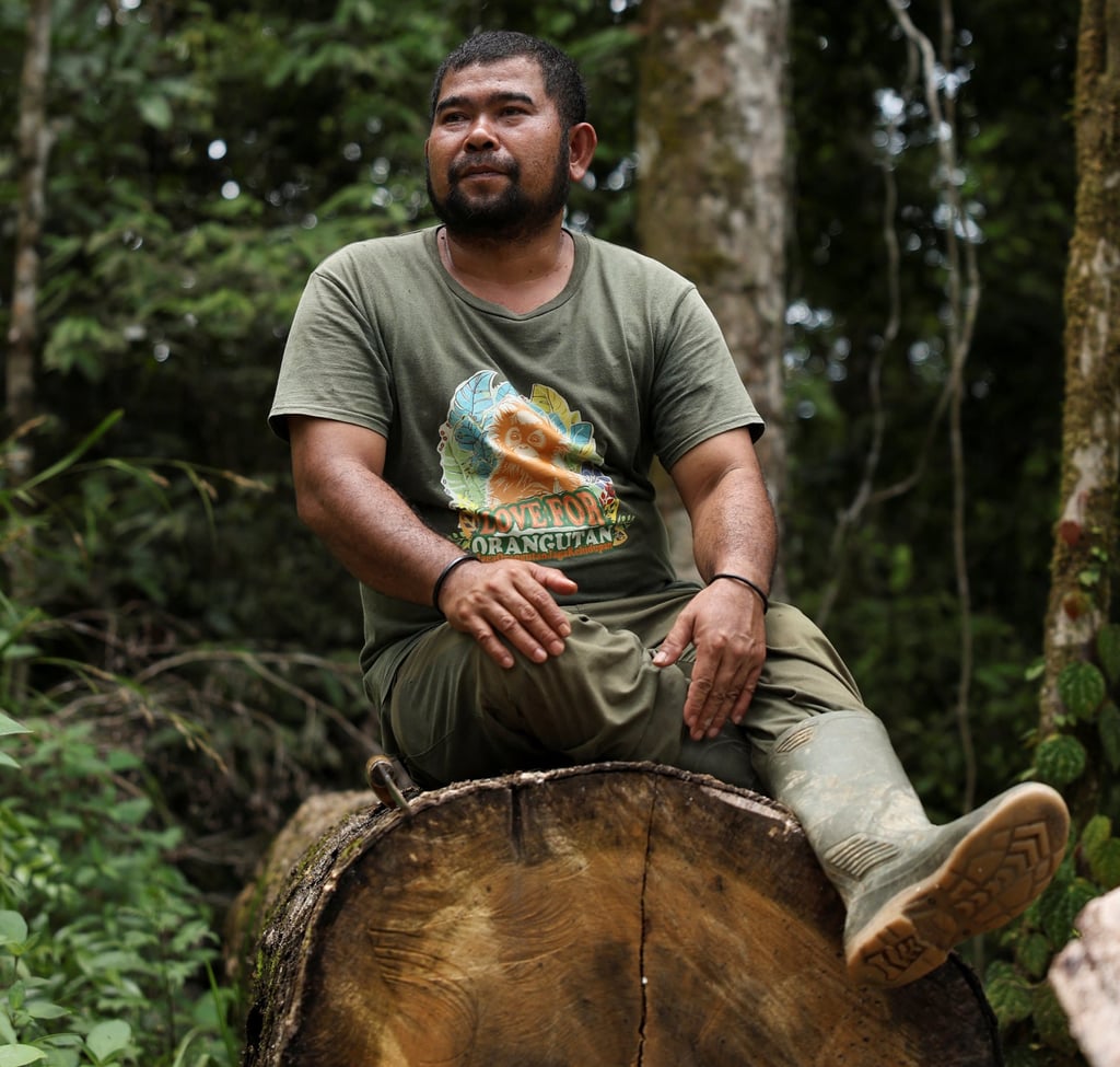 Siagian sits on a log he says is a remnant of illegal logging in the forests of Sipirok, North Sumatra province, on Monday. Photo: Reuters Siagian sits on a log he says is a remnant of illegal logging in the forests of Sipirok, North Sumatra province, on Monday. Photo: Reuters