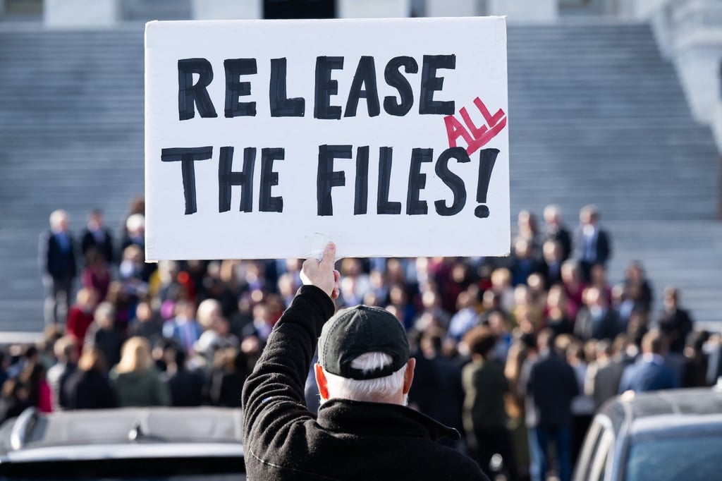 A protester holds a sign related to the release of the Jeffrey Epstein case files outside the US Capitol in Washington, last month. Photo: TNS A protester holds a sign related to the release of the Jeffrey Epstein case files outside the US Capitol in Washington, last month. Photo: TNS