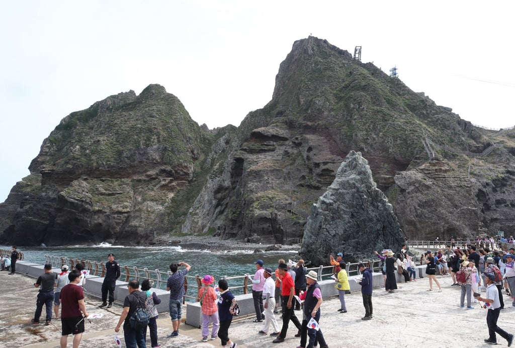 Visitors tour South Korea’s easternmost Dokdo islets, also known as Takeshima in Japan, in August 2019. The islets sit roughly halfway between South Korea’s Ulleungdo island and Japan’s Oki Islands. Photo: EPA-EFE/Yonhap Visitors tour South Korea’s easternmost Dokdo islets, also known as Takeshima in Japan, in August 2019. The islets sit roughly halfway between South Korea’s Ulleungdo island and Japan’s Oki Islands. Photo: EPA-EFE/Yonhap