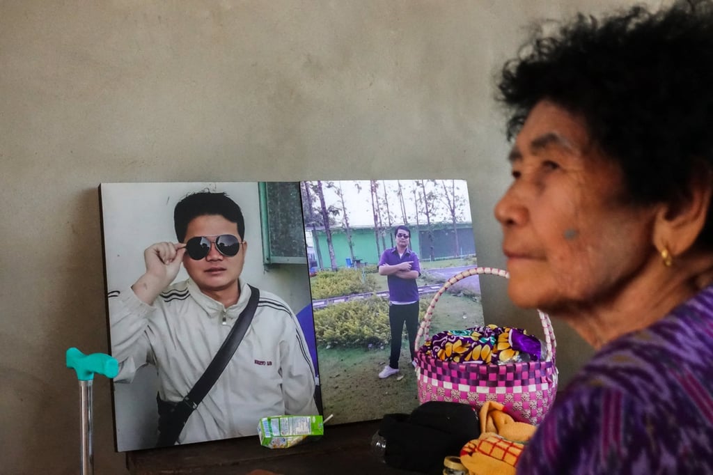 On Rinthalak, 80, mother of Sudthisak Rinthalak, sits next to his pictures at their house in Nong Khai province, Thailand, on December 5. Photo: Reuters