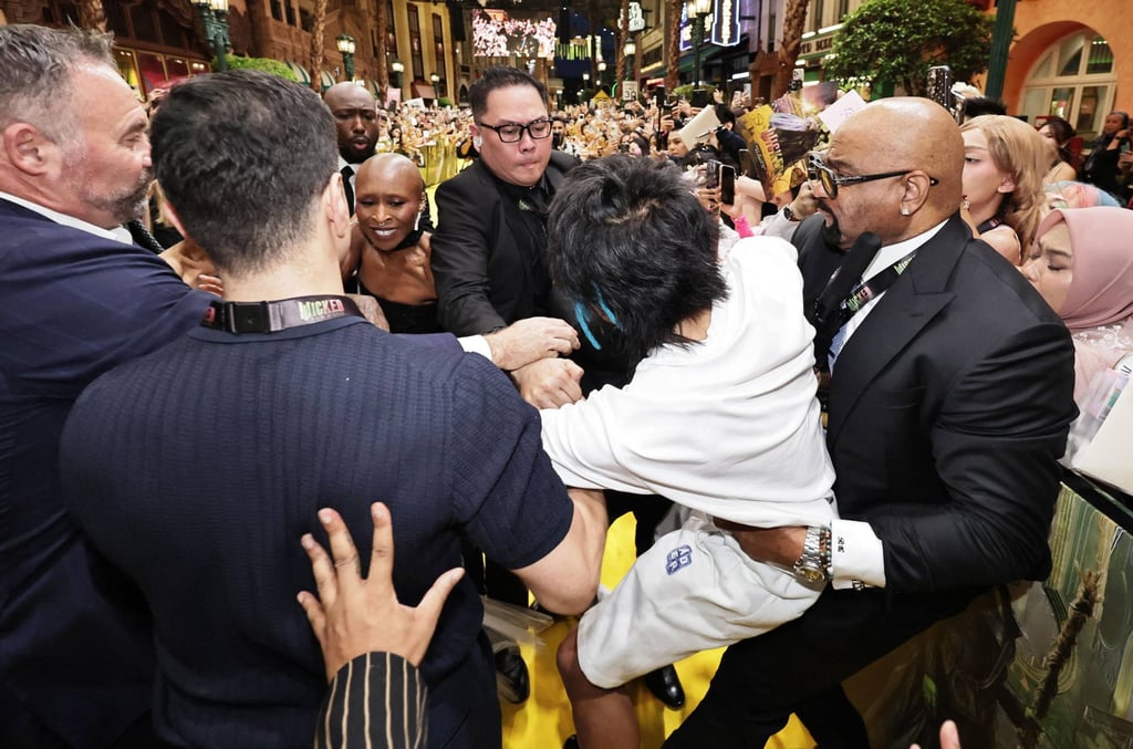 Security guards seize a man (centre) as he tries to grab Ariana Grande at the “Wicked: For Good” premiere in Singapore on November 14, while co-star Cynthia Erivo (third from left) reacts. Photo: AFP