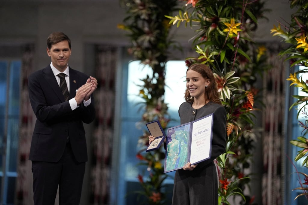 Ana Corina Sosa Machado (right), daughter of Nobel Peace Prize laureate Maria Corina Machado, accepts the award on behalf of her mother during an award ceremony on Tuesday. Photo: Reuters Ana Corina Sosa Machado (right), daughter of Nobel Peace Prize laureate Maria Corina Machado, accepts the award on behalf of her mother during an award ceremony on Tuesday. Photo: Reuters