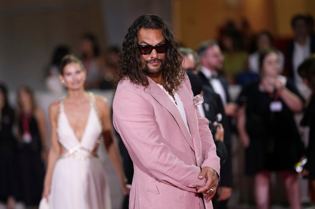 Jason Momoa opted for a pink relaxed-cut suit for the Venice Film Festival premiere of In the Hand of Dante. Photo: Invision/AP Jason Momoa opted for a pink relaxed-cut suit for the Venice Film Festival premiere of In the Hand of Dante. Photo: Invision/AP