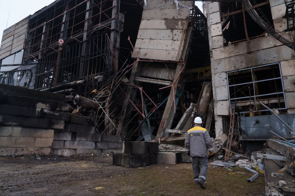 A worker walks in front of a production hall on Wednesday after a Russian missile attack at a power plant in Ukraine. Photo: AP