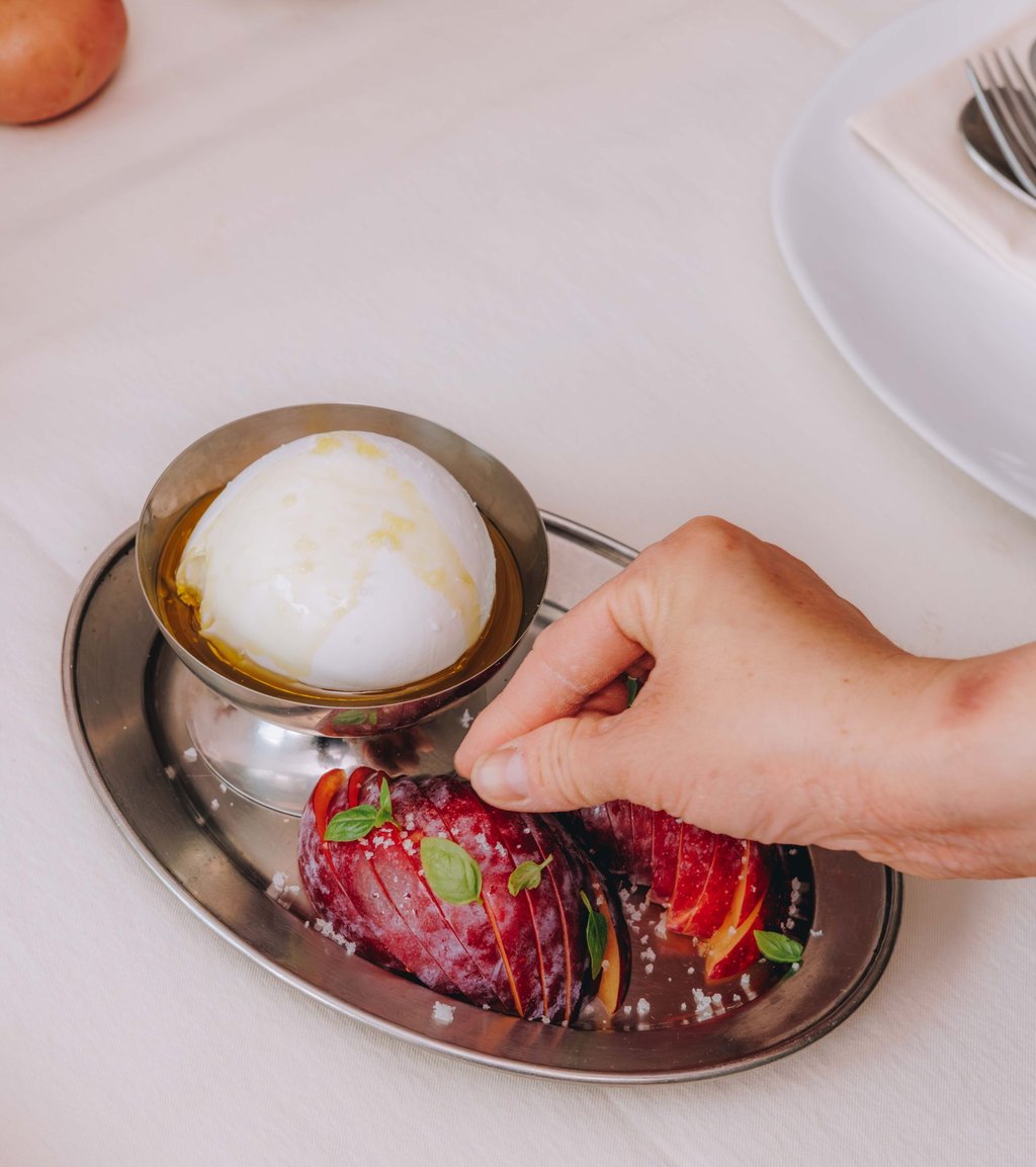 Sliced plum with olive oil-drizzled burrata. Photo: Jocelyn Tam Sliced plum with olive oil-drizzled burrata. Photo: Jocelyn Tam