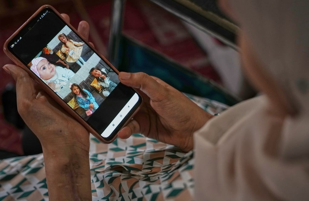 Haneen al-Mabhouh looks at photos of her daughters, all killed in an Israeli air strike, in her family home in Nuseirat, central Gaza Strip, on November 6. Photo: AP Haneen al-Mabhouh looks at photos of her daughters, all killed in an Israeli air strike, in her family home in Nuseirat, central Gaza Strip, on November 6. Photo: AP