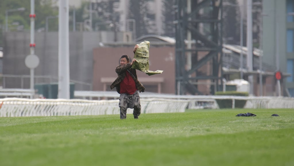 A man runs onto the Sha Tin track during the running of Sunday’s Group One Hong Kong Cup.