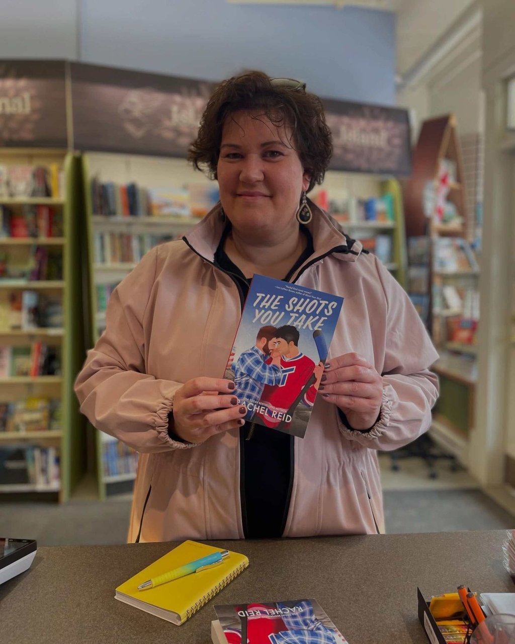 Rachel Reid holding a copy of The Shots You Take at a bookshop. Photo: @bookmarkpei/Instagram Rachel Reid holding a copy of The Shots You Take at a bookshop. Photo: @bookmarkpei/Instagram