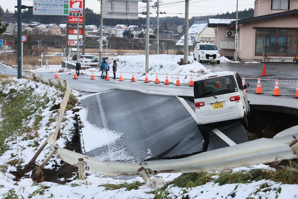 A car is seen stranded on a stretch of collapsed road in Aomori prefecture, northeastern Japan, last Tuesday following a powerful magnitude 7.5 earthquake. Photo: Jiji Press/EPA A car is seen stranded on a stretch of collapsed road in Aomori prefecture, northeastern Japan, last Tuesday following a powerful magnitude 7.5 earthquake. Photo: Jiji Press/EPA
