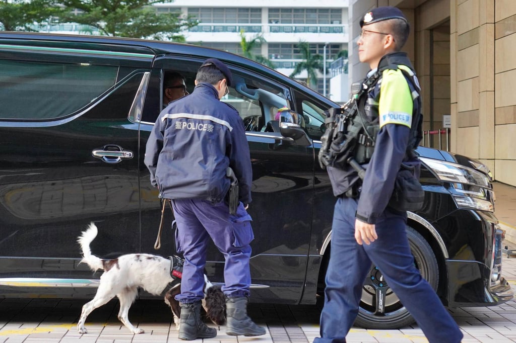 Police stop and search vehicles passing through Tung Chau Street outside West Kowloon Court. Photo: Karma Lo