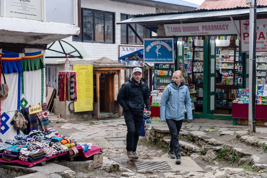 Foreign tourists walk past businesses in the town of Namche Bazaar, Nepal, in 2023. Photo: AFP