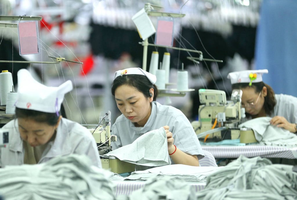 Workers sew garments at a textile factory in Qingdao, in eastern China’s Shandong province. Photo: AFP