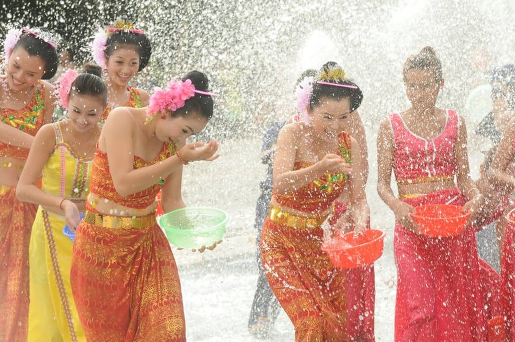 Dai New Year is a time for celebrations; in the case above, women throw water over each other. Photo: Xinhua