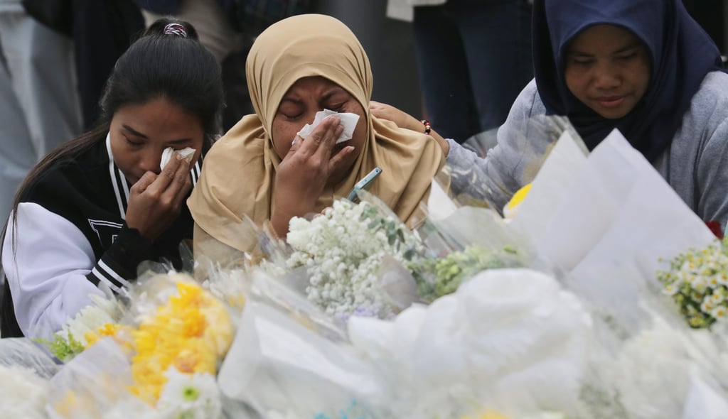 Indonesian women cry for their compatriots in front of a makeshift altar at the Wang Fuk Court fire disaster site on December 7. Photo: Zuma/dpa Indonesian women cry for their compatriots in front of a makeshift altar at the Wang Fuk Court fire disaster site on December 7. Photo: Zuma/dpa