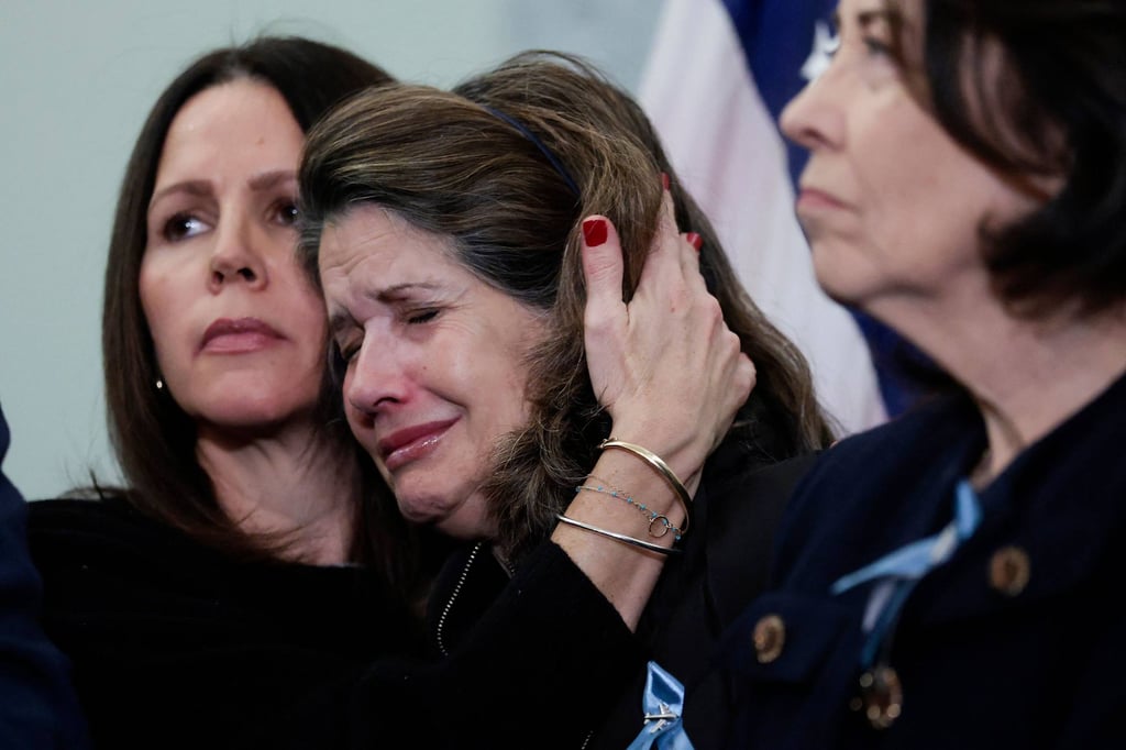 Christina Stovall (second from right), who lost her son in the January plane crash, is comforted by Amy Hunter, who lost her cousin, at a Monday press conference in Washington. Photo: Getty Images/AFP