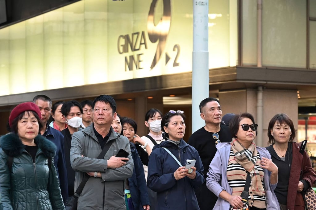 Members of a Chinese tour group wait to cross a road in Tokyo’s Ginza shopping district. Photo: AFP