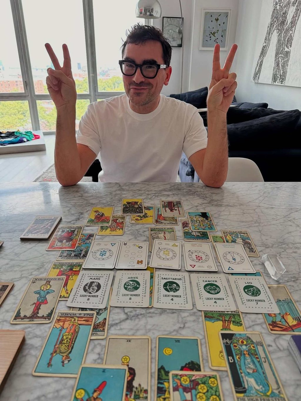 Dan Levy and his tarot spread from a reading with Trevor Ballin in August. Photo: @trevor.ballin/Instagram