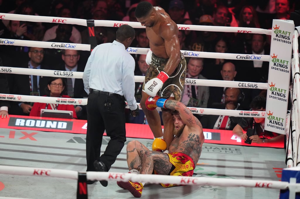 Jake Paul falls on the canvas after being hit by Anthony Joshua. Photo: AP