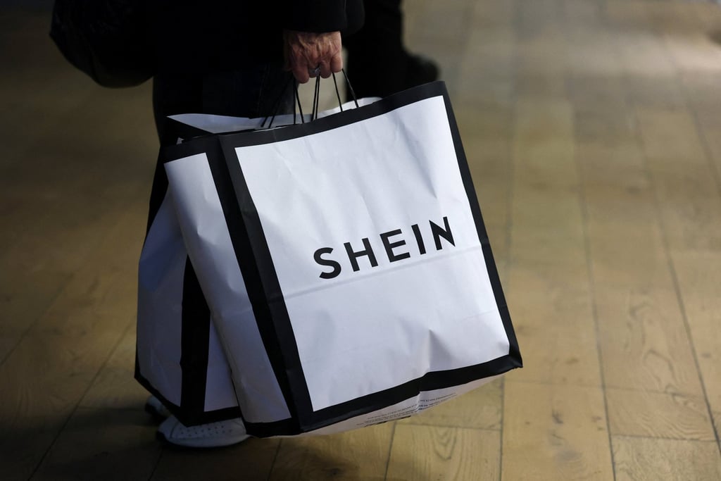 A customer holds Shein shopping bags at the brand’s first physical store, which opened in Paris in November. Photo: Reuters
