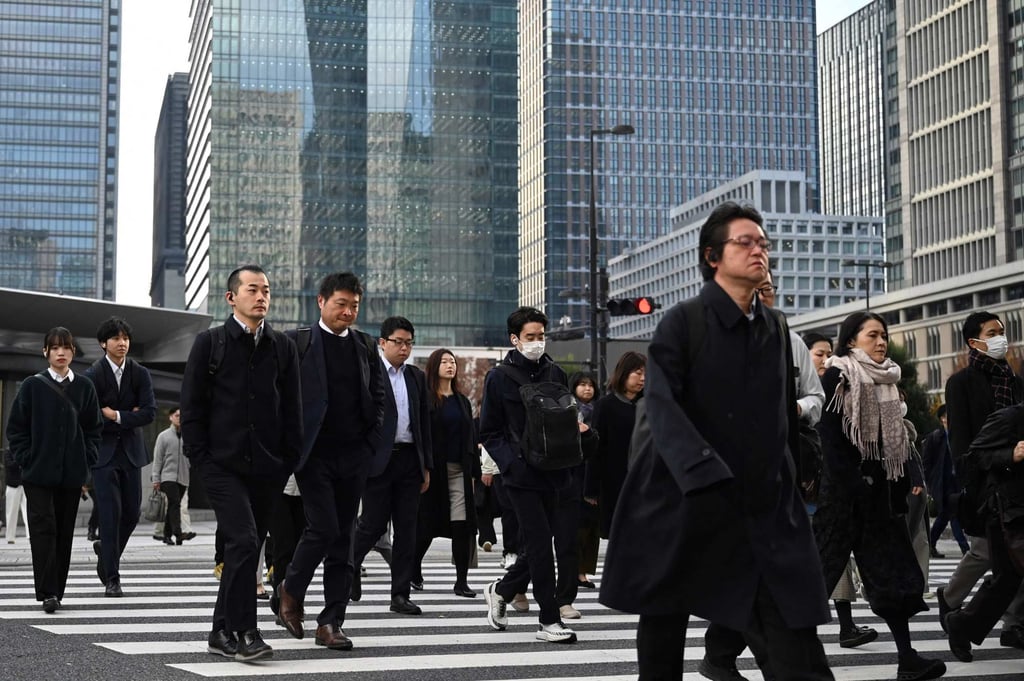 People cross a road in Tokyo earlier this month. Fifty-year mortgages are transforming home ownership for young buyers in Japan. Photo: AFP