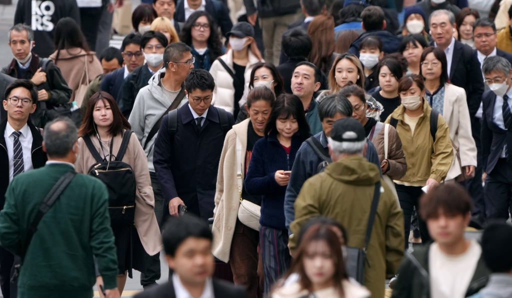 Commuters walk along Shinjuku Street in Tokyo. Photo: EPA-EFE
