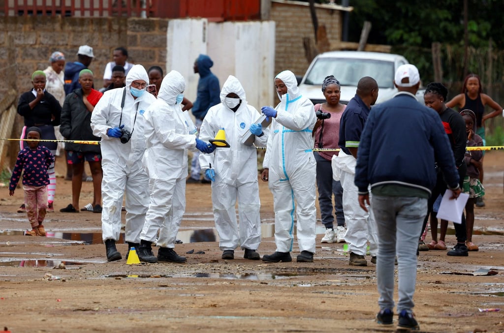 Forensic officials at the scene. Photo: Reuters