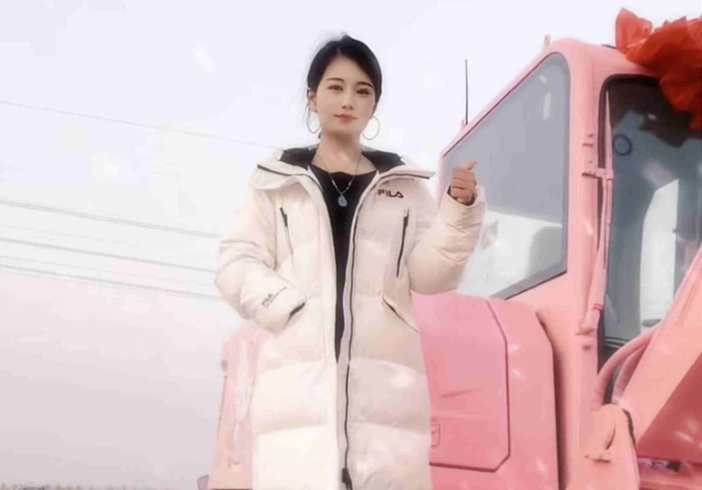 The 35-year-old Zhang poses atop her bright pink excavator. Photo: Douyin
