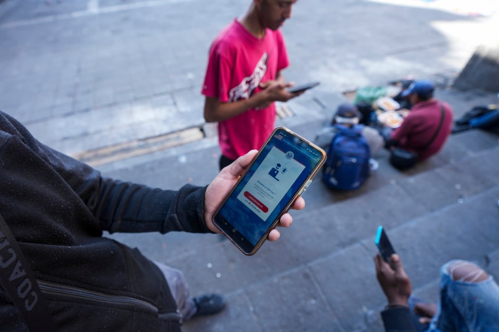 A Venezuelan migrant shows the CBP Home app on his mobile phone in January. Photo: AP