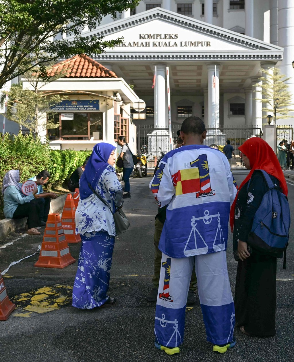 Supporters of Malaysia’s jailed former prime minister Najib Razak wait outside the Kuala Lumpur High Court during a court hearing on Monday. Photo: AFP