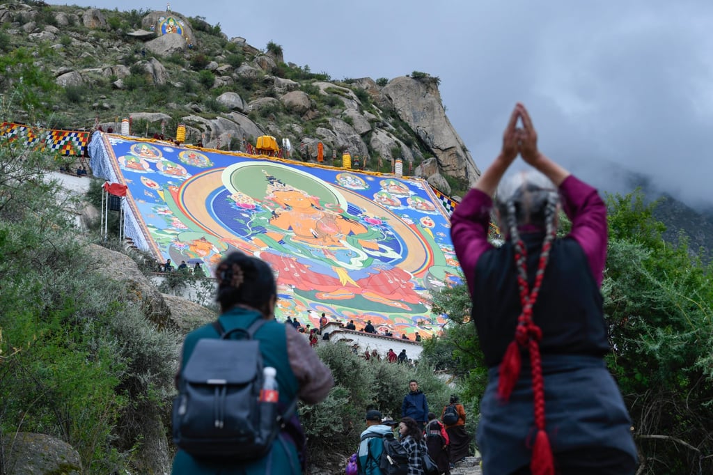 In Lhasa in August, worshippers stand before a huge Thangka painting at the Drepung Monastery for the Shoton Festival. An international symposium on the sixth Dalai Lama organised by India has sparked ire in China. Photo: China News Service/VCG via Getty Images