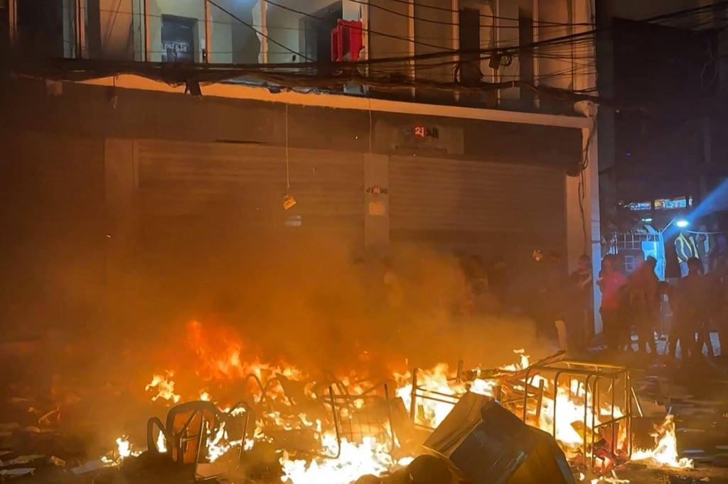 A fire burns outside the offices of Prothom Alo in Dhaka on Friday, as unrest followed the death of youth leader Sharif Osman Hadi. Photo: AFP